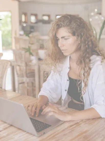 Image of young woman on a laptop shopping for local Eastbourne business supplies for her small home office side hustle business